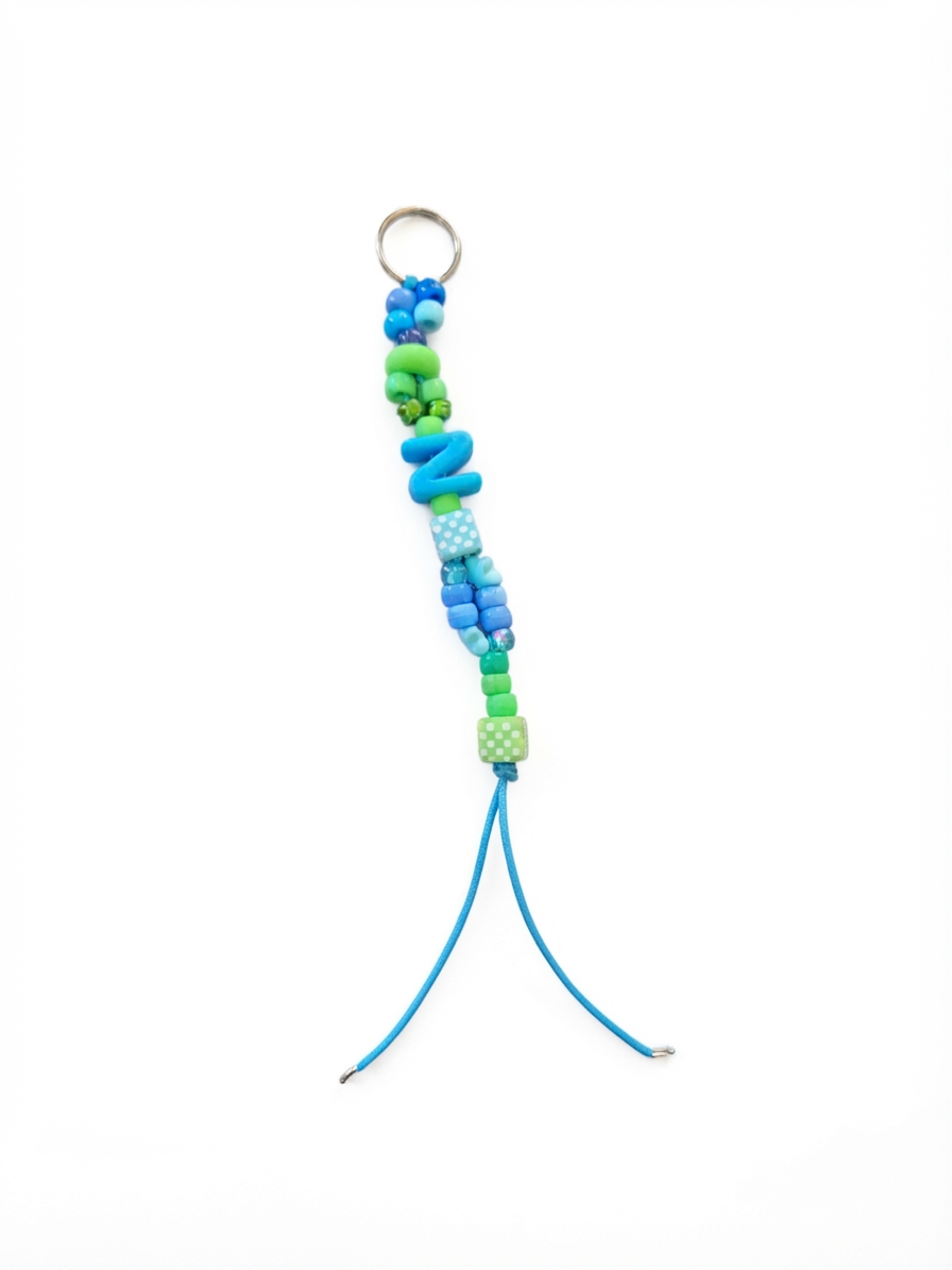 Custom Initial Bag Charm in blue and green colourway with letter bead