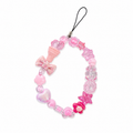 Scoop de Jour phone charm with pink ice cream cone, bow, heart, flower, and star charms on a beaded pink strand