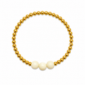 Vanilla Sparkle Bracelet featuring gold beads with three creamy white focal beads
