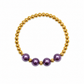 Grape Glitter Bracelet featuring gold beads with three large shimmery purple focal beads